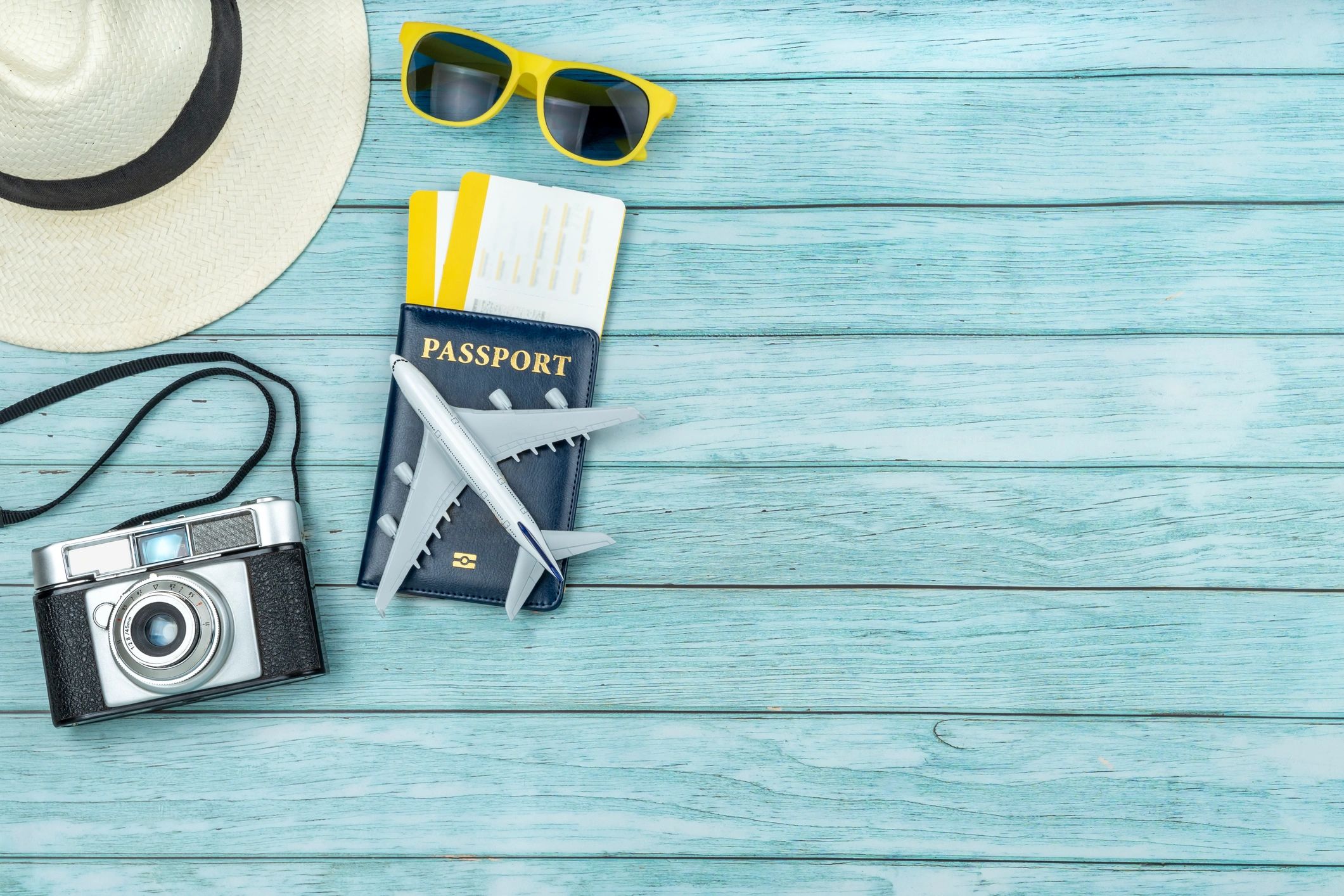 Flat lay of travel accessories with passport and boarding passes